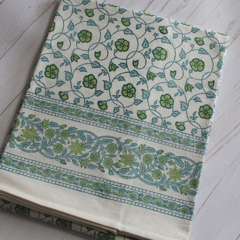 Hand block printed blue and green floral pattern on cotton square tablecloth for coastal home decor