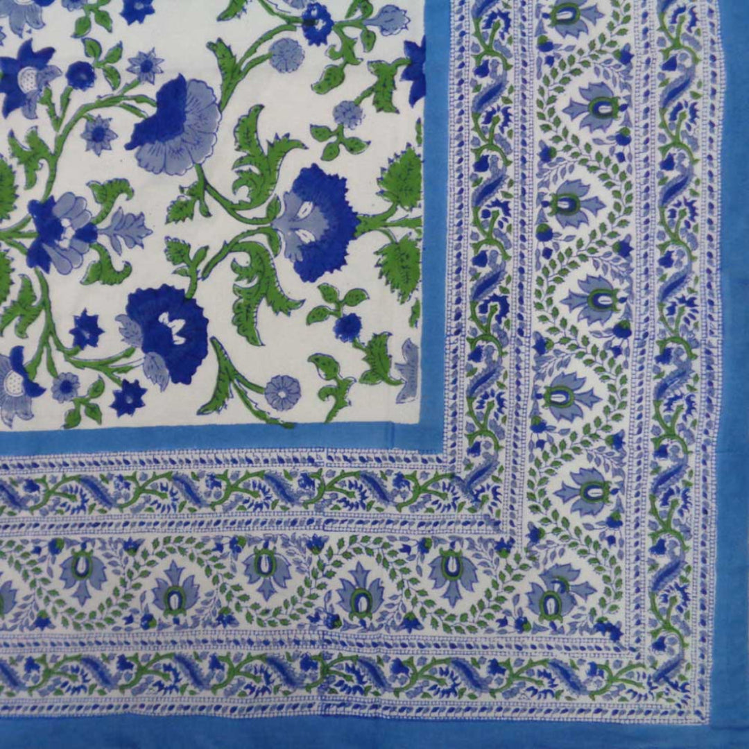 Detail of the blue and green block printed border design along the edge of a cotton tablecloth