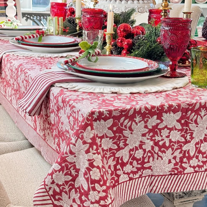 Closeup of Red holiday floral patterened tablecloth, hand block printed on premium cotton for family heirloom.