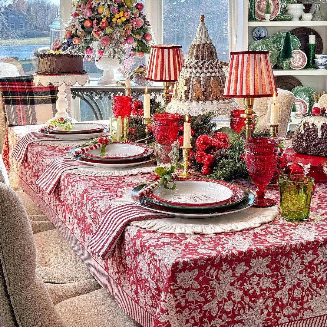 Red white floral christmas tablecloth set with holiday dinner with decorative accents