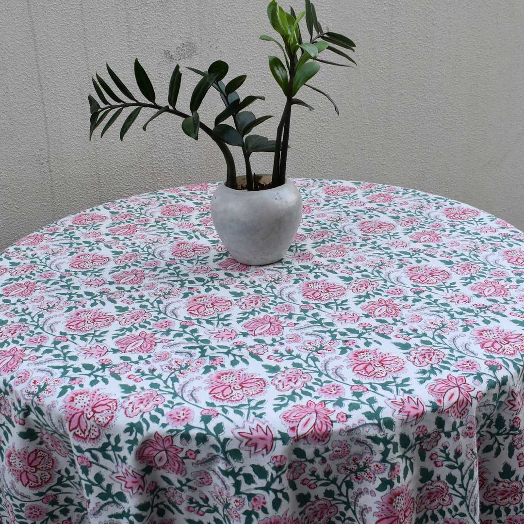 Close up of the pink green floral block printed pattern on a cotton round tablecloth
