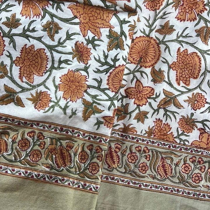 Closeup of Orange green floral pattern block printed on premium cotton tablecover