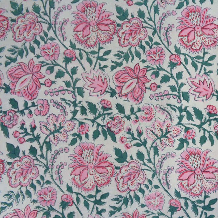 Detailed shot of pink green block printed pattern of large rectangular holiday table cover