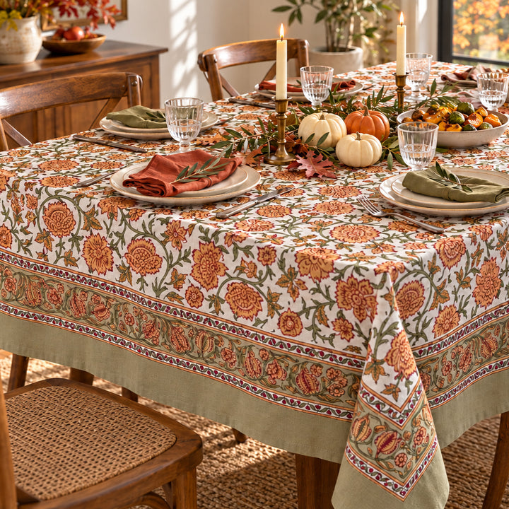 Close-up corner view showing the green geometric border and floral block print of a rectangular tablecloth set for a Fall Gathering