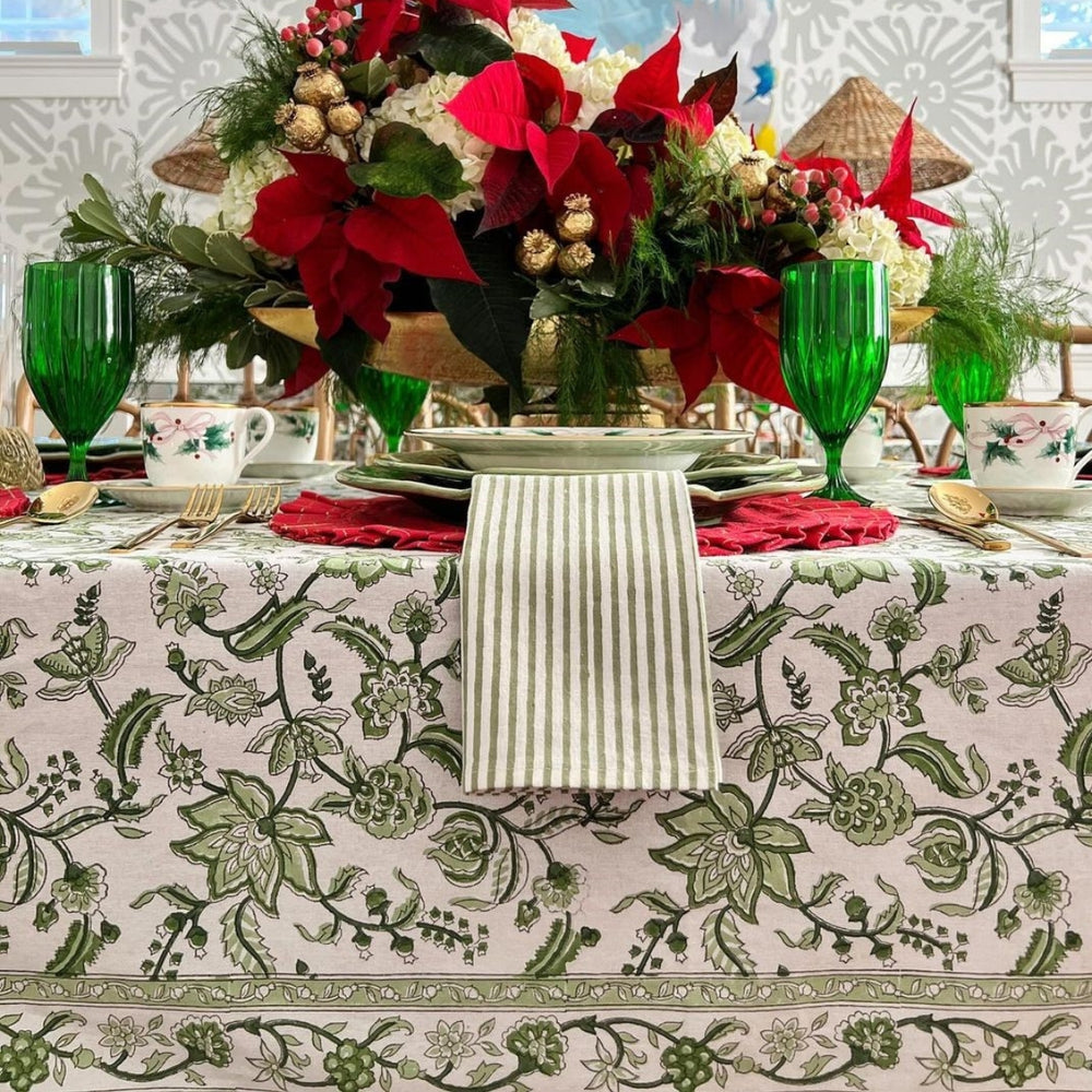Large rectangular cotton tablecloth featuring hand block printed monochrome green floral country style pattern in Christmas setting