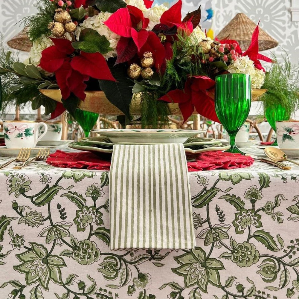 Large rectangular cotton tablecloth featuring hand block printed monochrome green floral country style pattern in CHristmas setting