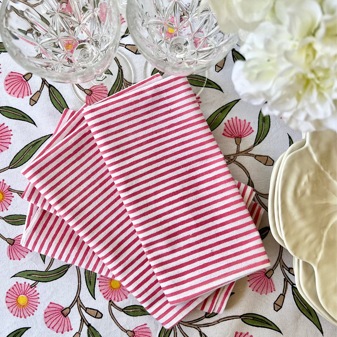 Pink striped hand block printed napkin set of 4 made of pure cotton folded and kept on a cotton block printed tablecloth