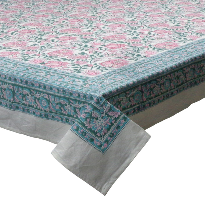 Detail shot of block printed Floral patterned tablecloth with blue green intricate border on a white premium cotton fabric