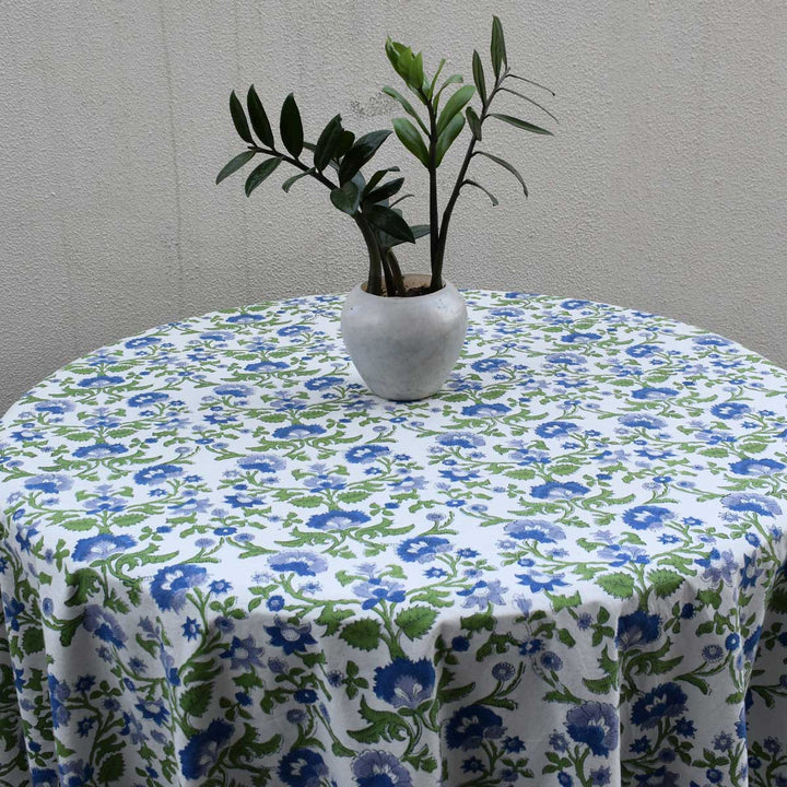 Close up of blue and green hand block printed floral pattern on round cotton tablecloth