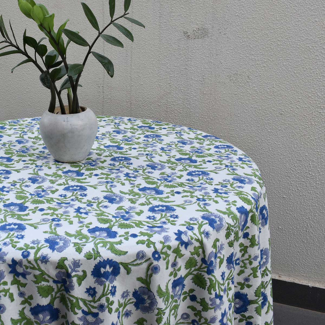 Side angle of 90 inch  round hand block printed tablecloth featuring blue green fabric pattern