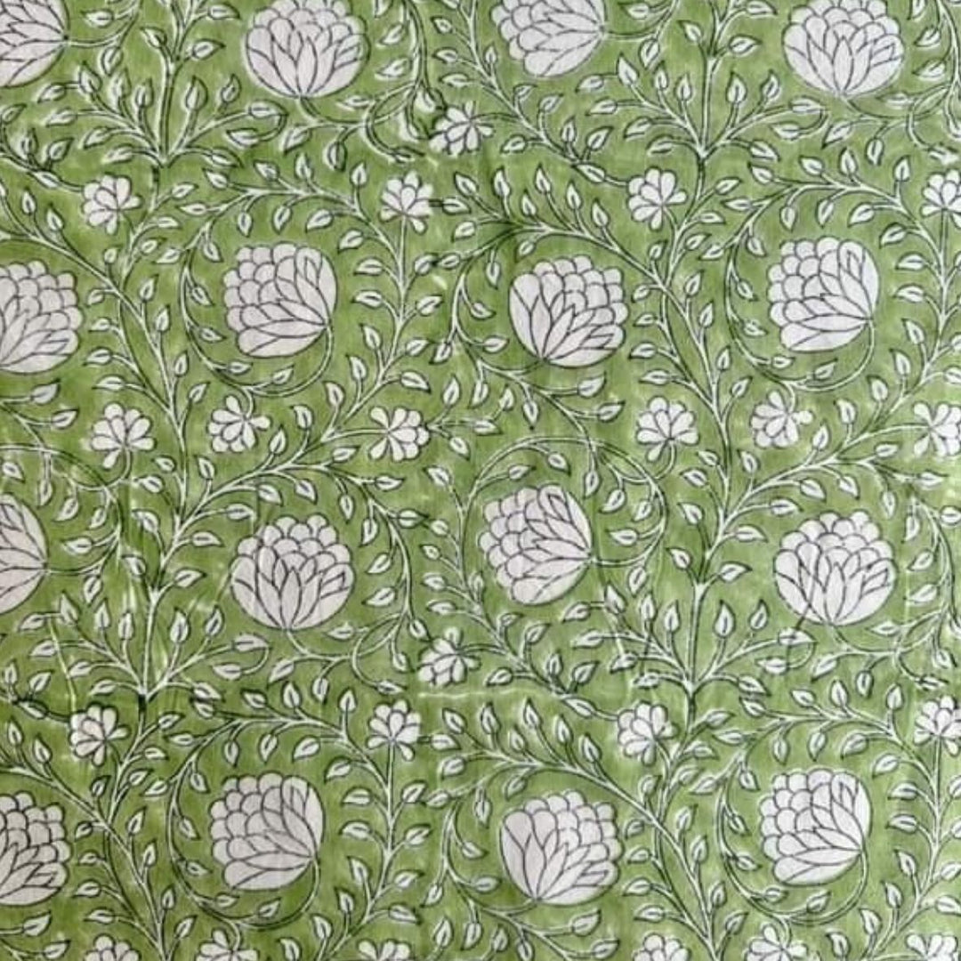 
Close-up of a round Eden tablecloth edge in green and white hand block print
