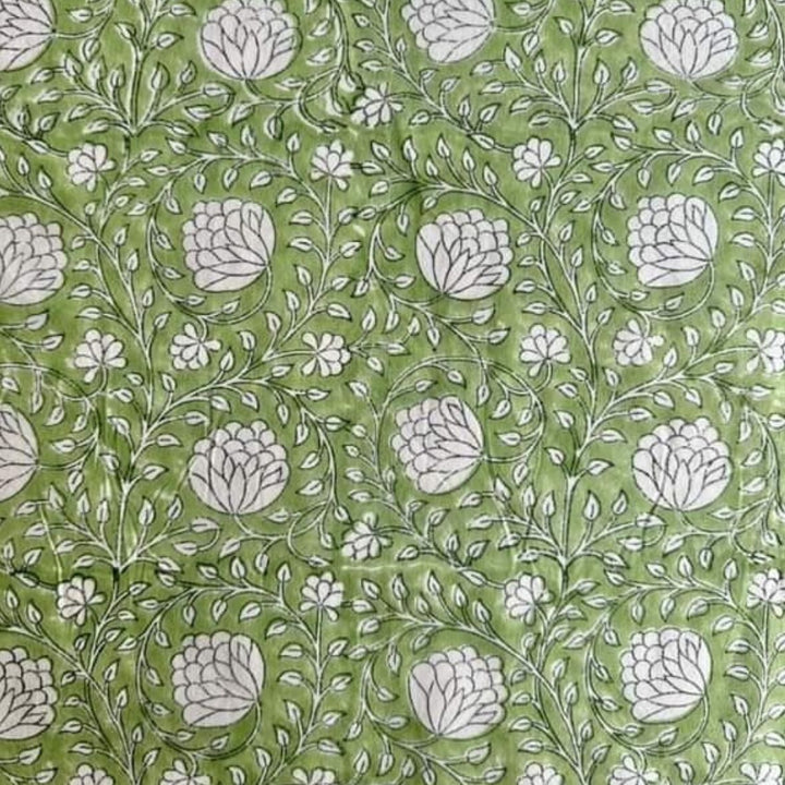 
Close-up of a round Eden tablecloth edge in green and white hand block print